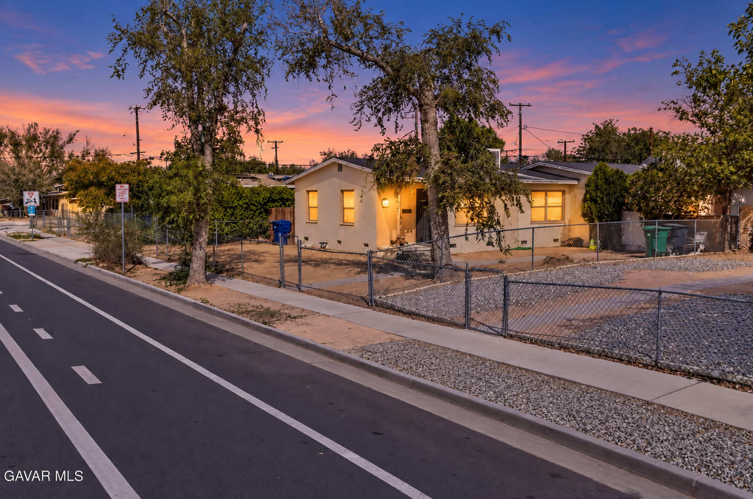Twilight front exterior of the duplex at 45348 10th Street W in Lancaster, California